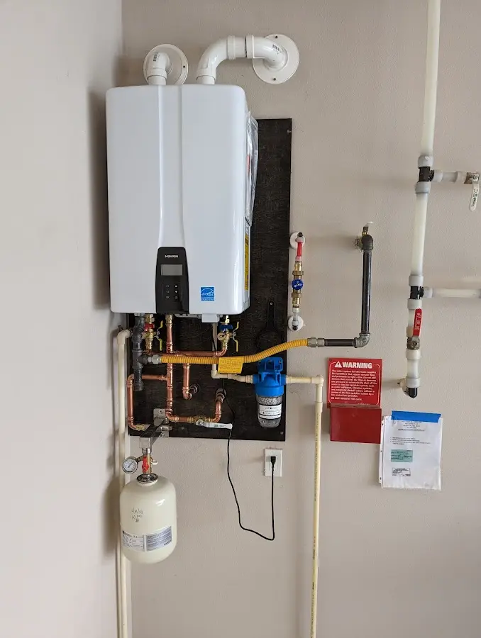 Professional plumber installing copper piping in a Camp Hill home